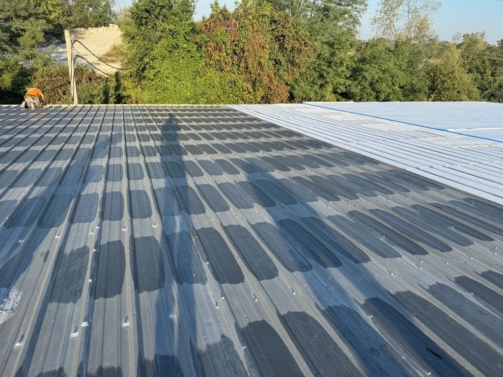 Metal retrofit roof on a commercial building installed by All Seasons Roofing