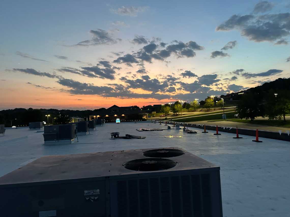All Seasons Roofing - flat roof at sunset